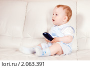 Удивленный малыш с пультом телевизора. Стоковое фото, фотограф Игорь Соколов / Фотобанк Лори