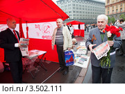Мужчина раздает газету "Правда" на митинге КПРФ, посвященном Дню победы, на Лубянской площади, Москва (2012 год). Редакционное фото, фотограф Николай Винокуров / Фотобанк Лори
