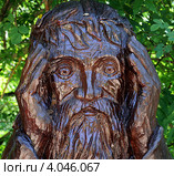 Деревянный божок придерживает руками венок из листьев на голове (2011 год). Редакционное фото, фотограф Олег Пчелов / Фотобанк Лори