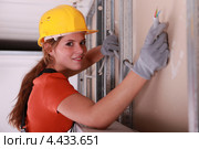 Девушка-электрик в каске за работой. Стоковое фото, фотограф Phovoir Images / Фотобанк Лори