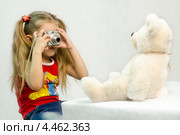 Девочка фотографирует мишку цифровым фотоаппаратом (2013 год). Редакционное фото, фотограф Иванов Алексей / Фотобанк Лори