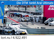 Автомобиль BMW M3 DTM на фоне питлейонов трассы Moscow Raceway в Подмосковье 3 августа 2013. Редакционное фото, фотограф Николай Винокуров / Фотобанк Лори