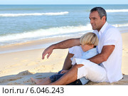 Father and son sitting on a beach. Стоковое фото, фотограф Phovoir Images / Фотобанк Лори