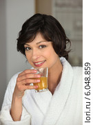 pretty woman in bathrobe having glass of orange juice. Стоковое фото, фотограф Phovoir Images / Фотобанк Лори