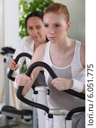 Women using exercise machines at the gym. Стоковое фото, фотограф Phovoir Images / Фотобанк Лори