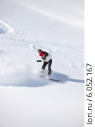 Adventurous man snowboarding down hill. Стоковое фото, фотограф Phovoir Images / Фотобанк Лори