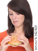 Woman eating a hamburger. Стоковое фото, фотограф Phovoir Images / Фотобанк Лори