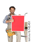 a handyman holding a panel. Стоковое фото, фотограф Phovoir Images / Фотобанк Лори