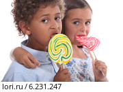 couple of children with lollypops. Стоковое фото, фотограф Phovoir Images / Фотобанк Лори
