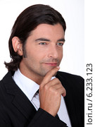 Pensive man dressed in suit. Стоковое фото, фотограф Phovoir Images / Фотобанк Лори