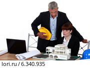Experienced architect giving a young colleague advice. Стоковое фото, фотограф Phovoir Images / Фотобанк Лори