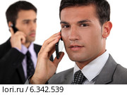 Businessmen talking on their mobile phones. Стоковое фото, фотограф Phovoir Images / Фотобанк Лори