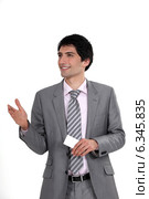 Executive offering a handshake and business card. Стоковое фото, фотограф Phovoir Images / Фотобанк Лори