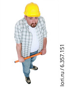 Tradesman holding a tool. Стоковое фото, фотограф Phovoir Images / Фотобанк Лори
