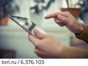Close up of male hand using digital tablet. Стоковое фото, агентство Ingram Publishing / Фотобанк Лори