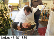 Священник крестит младенца (2014 год). Редакционное фото, фотограф Дмитрий Неумоин / Фотобанк Лори