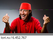 Man in red dress wearing fez hat. Стоковое фото, фотограф Elnur / Фотобанк Лори