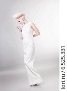 blond beautiful woman in white dress with creative hairstyle. Стоковое фото, фотограф Александр Буц / Фотобанк Лори
