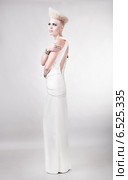 blond magnificent woman in white dress with creative hairstyle. Стоковое фото, фотограф Александр Буц / Фотобанк Лори