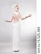 blond woman in dress with creative hairstyle and nacked back. Стоковое фото, фотограф Александр Буц / Фотобанк Лори