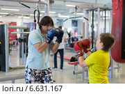 Отец с сыном боксируют в спортзале (2014 год). Редакционное фото, фотограф Володина Ольга / Фотобанк Лори