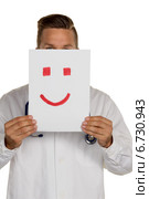 doctor holding smiley face before. Стоковое фото, фотограф Erwin Wodicka / Фотобанк Лори