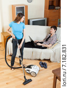 woman doing house cleaning during man resting. Стоковое фото, фотограф Яков Филимонов / Фотобанк Лори