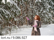 Happy red-haired woman having fun on win. Стоковое фото, фотограф Roberts Ratuts / PantherMedia / Фотобанк Лори