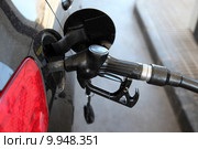 Gas station pump nozzle in the cars fuel tank. Стоковое фото, фотограф Philip Lange / PantherMedia / Фотобанк Лори