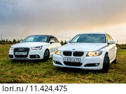 Audi A1 and BMW E90 318i (2015 год). Редакционное фото, фотограф Art Konovalov / Фотобанк Лори