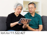 Asian old couple using tablet. Стоковое фото, фотограф Leung Cho Pan / PantherMedia / Фотобанк Лори