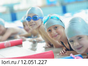 group of happy kids children at swimming pool class learning to swim. Стоковое фото, фотограф Benis Arapovic / PantherMedia / Фотобанк Лори