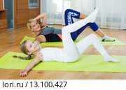 Positive mother and little daughter working out at home. Стоковое фото, фотограф Яков Филимонов / Фотобанк Лори