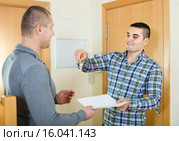 Two men at doorway with keys and contract. Стоковое фото, фотограф Яков Филимонов / Фотобанк Лори