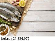 Two rainbow trouts on rustic wooden table, copy space. Стоковое фото, агентство BE&W Photo / Фотобанк Лори