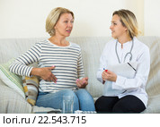 Young therapeutist and senior female with pain in belly. Стоковое фото, фотограф Яков Филимонов / Фотобанк Лори