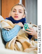 Young female having quinsy and fever and staying in couch. Стоковое фото, фотограф Яков Филимонов / Фотобанк Лори