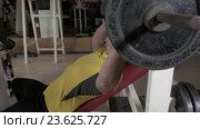 Young man at the gym doing exercise chest press with rod. Стоковое видео, видеограф Данил Руденко / Фотобанк Лори