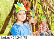 Cute boy in Injun's headdress playing with friends. Стоковое фото, фотограф Сергей Новиков / Фотобанк Лори