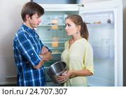 Frustraited starving female and man near fridge without any food. Стоковое фото, фотограф Яков Филимонов / Фотобанк Лори