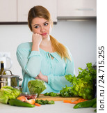 Young housewife tired of cooking vegetables in domestic kitchen. Стоковое фото, фотограф Яков Филимонов / Фотобанк Лори