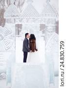 Winter wedding couple kissing in the middle of the ice figures in a snowy town, the bride in fur coat and white dress with veil, the groom wearing topcoat (2016 год). Редакционное фото, фотограф Евгений Майнагашев / Фотобанк Лори