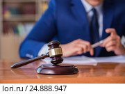 Handsome judge with gavel sitting in courtroom. Стоковое фото, фотограф Elnur / Фотобанк Лори