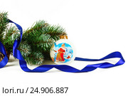 Artificial fir-tree branch with a ball, a background for New year and Christmas on a white background (2016 год). Редакционное фото, фотограф Artem Sobov / Фотобанк Лори