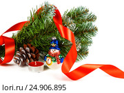 Toy snowman under a branch of an artificial Christmas tree with the cone and a red tape. Стоковое фото, фотограф Artem Sobov / Фотобанк Лори