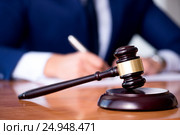 Handsome judge with gavel sitting in courtroom. Стоковое фото, фотограф Elnur / Фотобанк Лори