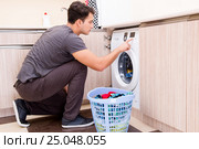 Young husband man doing laundry at home. Стоковое фото, фотограф Elnur / Фотобанк Лори