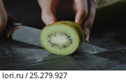 Chef Slices Kiwi on Wooden Table with Tropical Fruits. Стоковое видео, видеограф Станислав Панкратов / Фотобанк Лори