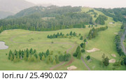Aerial View of the Golf Course in Mountains. Стоковое видео, видеограф Discovod / Фотобанк Лори