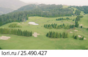 Aerial View of the Golf Course in Mountains. Стоковое видео, видеограф Discovod / Фотобанк Лори